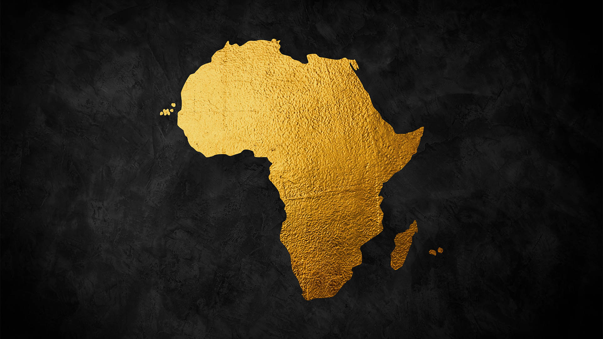 Africa continent shaped from golden glitter on a black background.