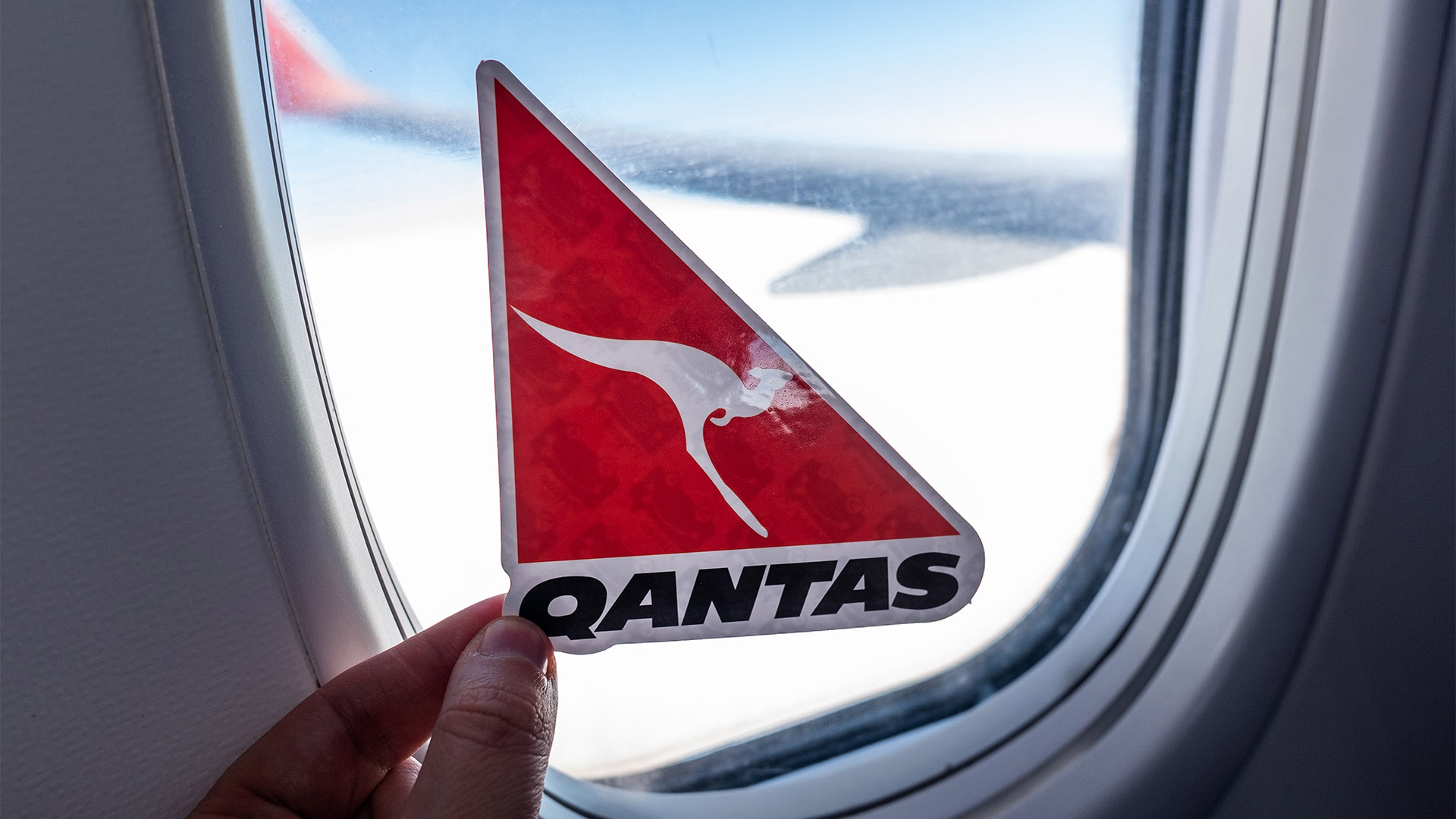 December 6, 2021, Sydney, Australia. The emblem of Qantas airlines on the background of the aircraft porthole.