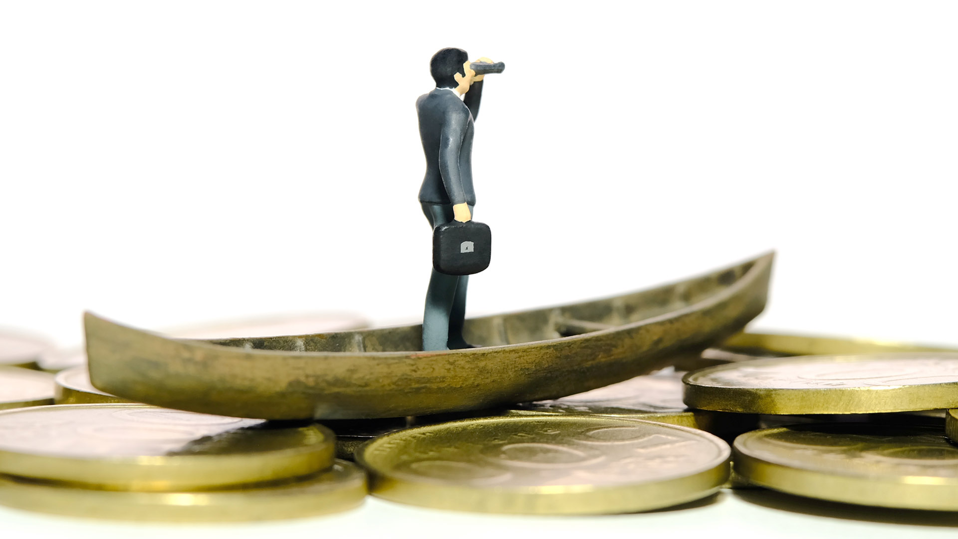 Miniature tiny people toy figure photography. Financial opportunity concept illustration. Businessman using binocular telescope sail with boat above coin money. Isolated on a white background. Image