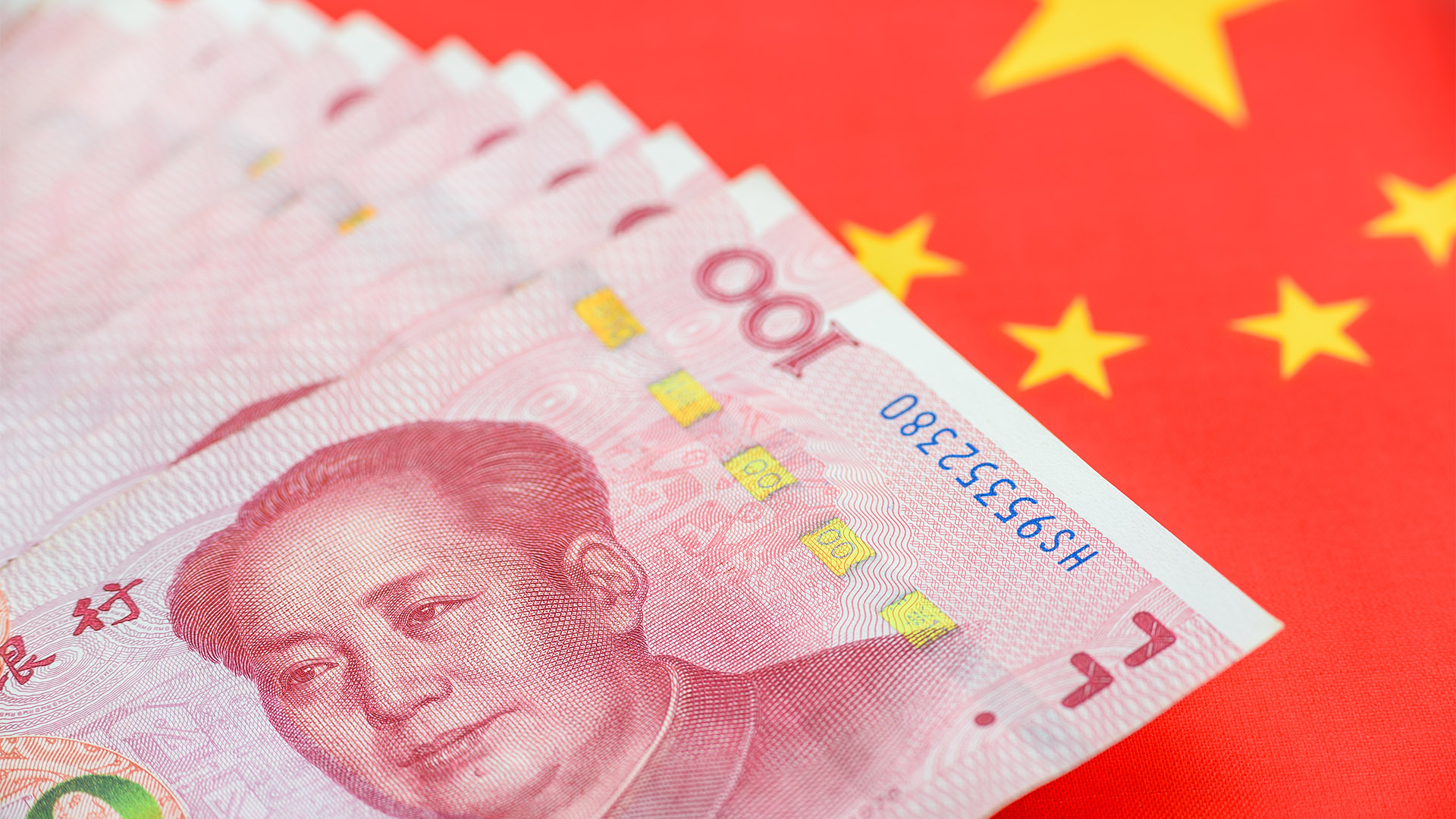 Money / currency of PBOC or people's bank of china. One hundred CNY Chinese yuan bill with a flag of China. 100 rmb or renminbi, depicts Beijing economy system, public banking policy and interest rate