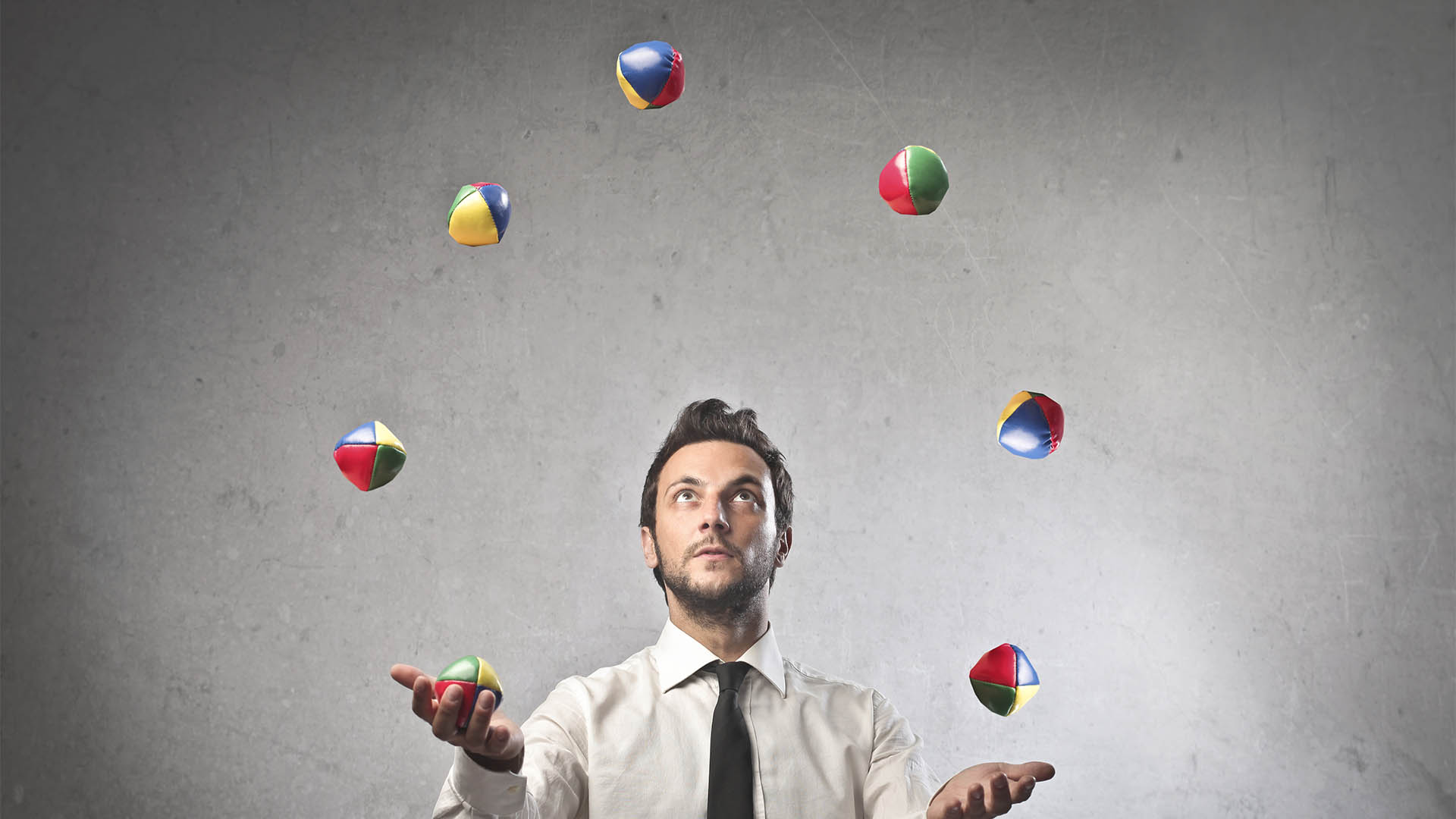 Young businessman juggling