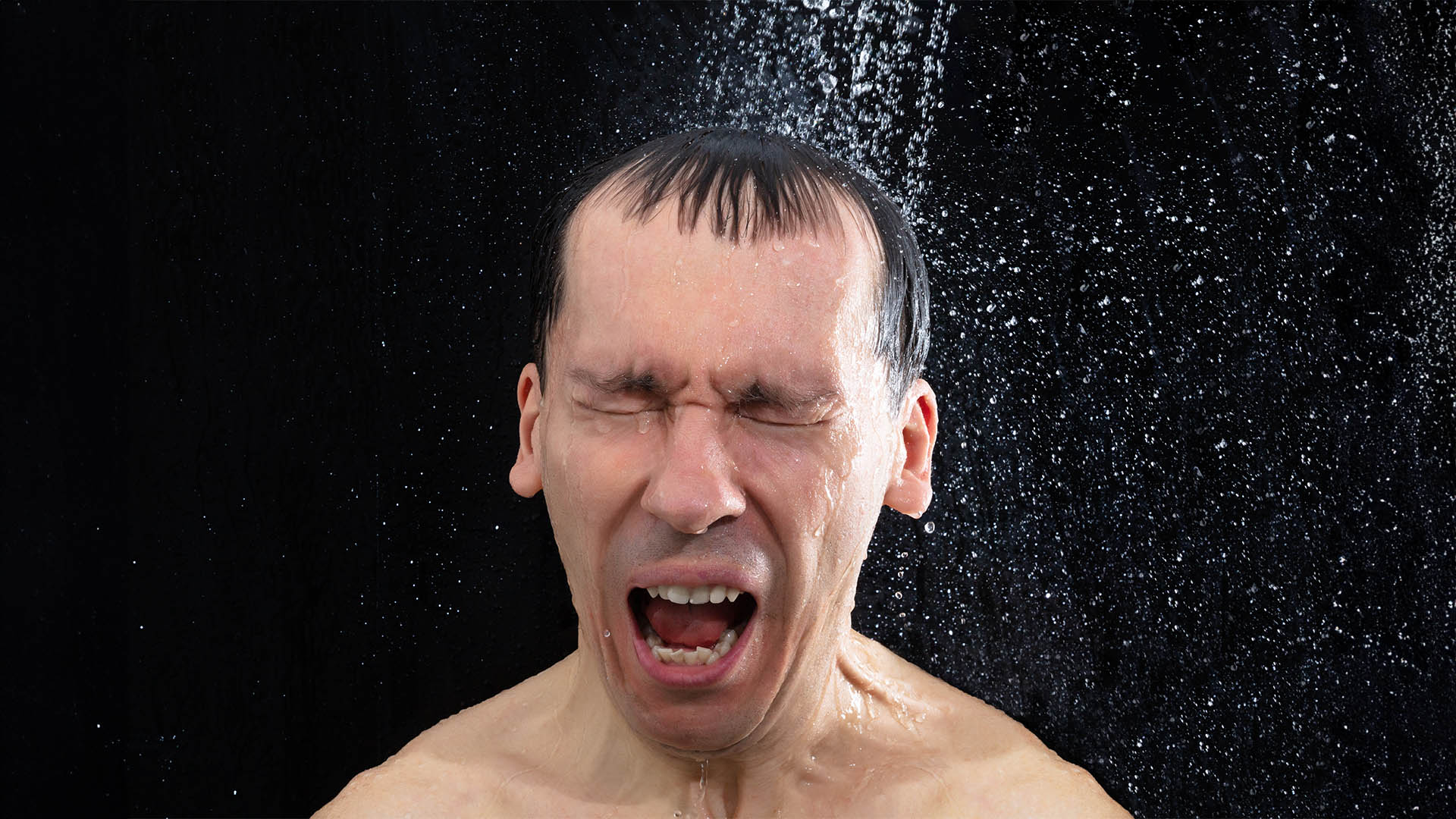 Portrait Of Young Man Taking Cold Shower In Bathroom