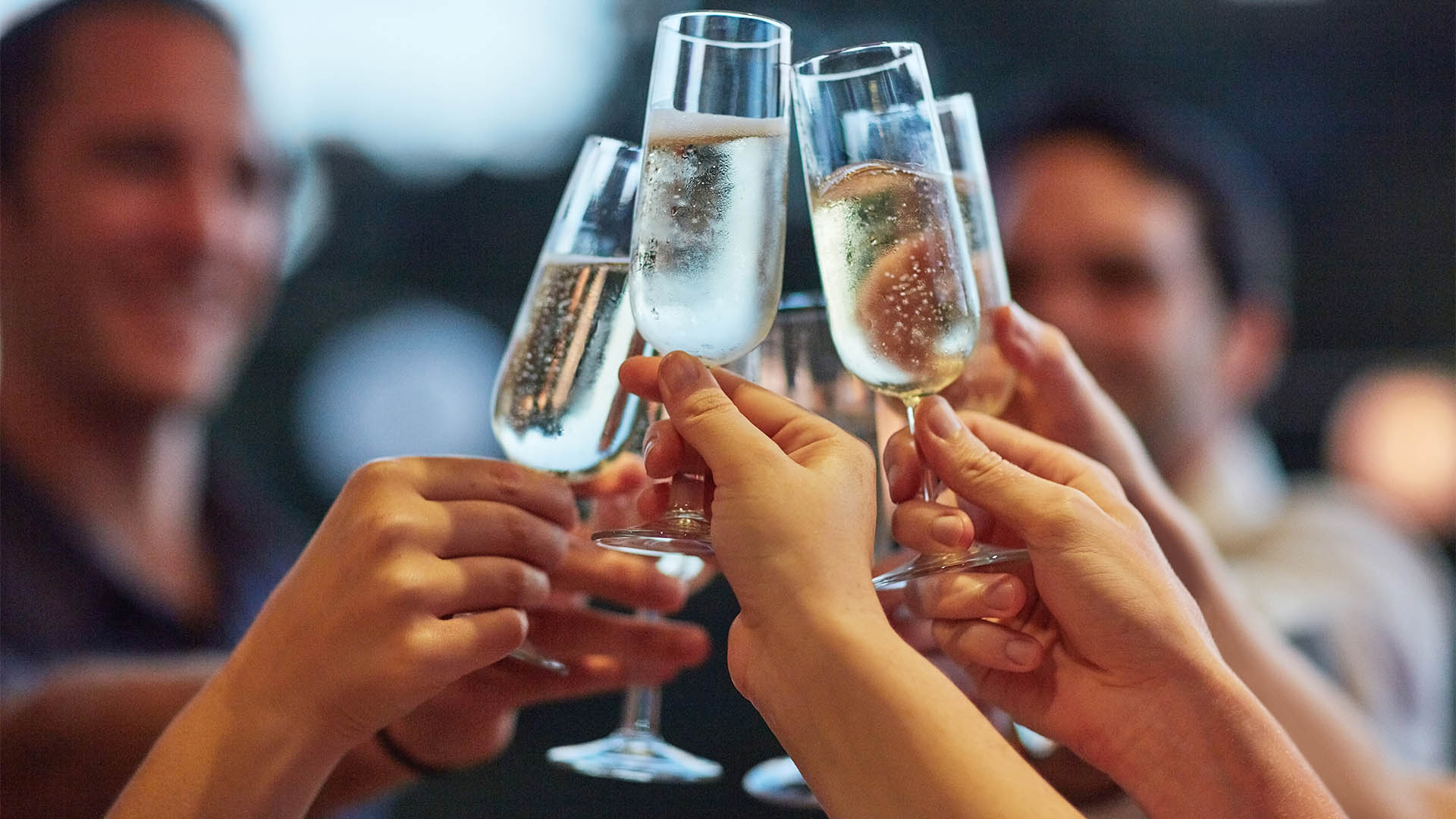 Bubbles, hands and toast with friends outdoor for celebration or social gathering together. Alcohol glass, champagne and cheers with group of people in backyard for milestone or new years for fun