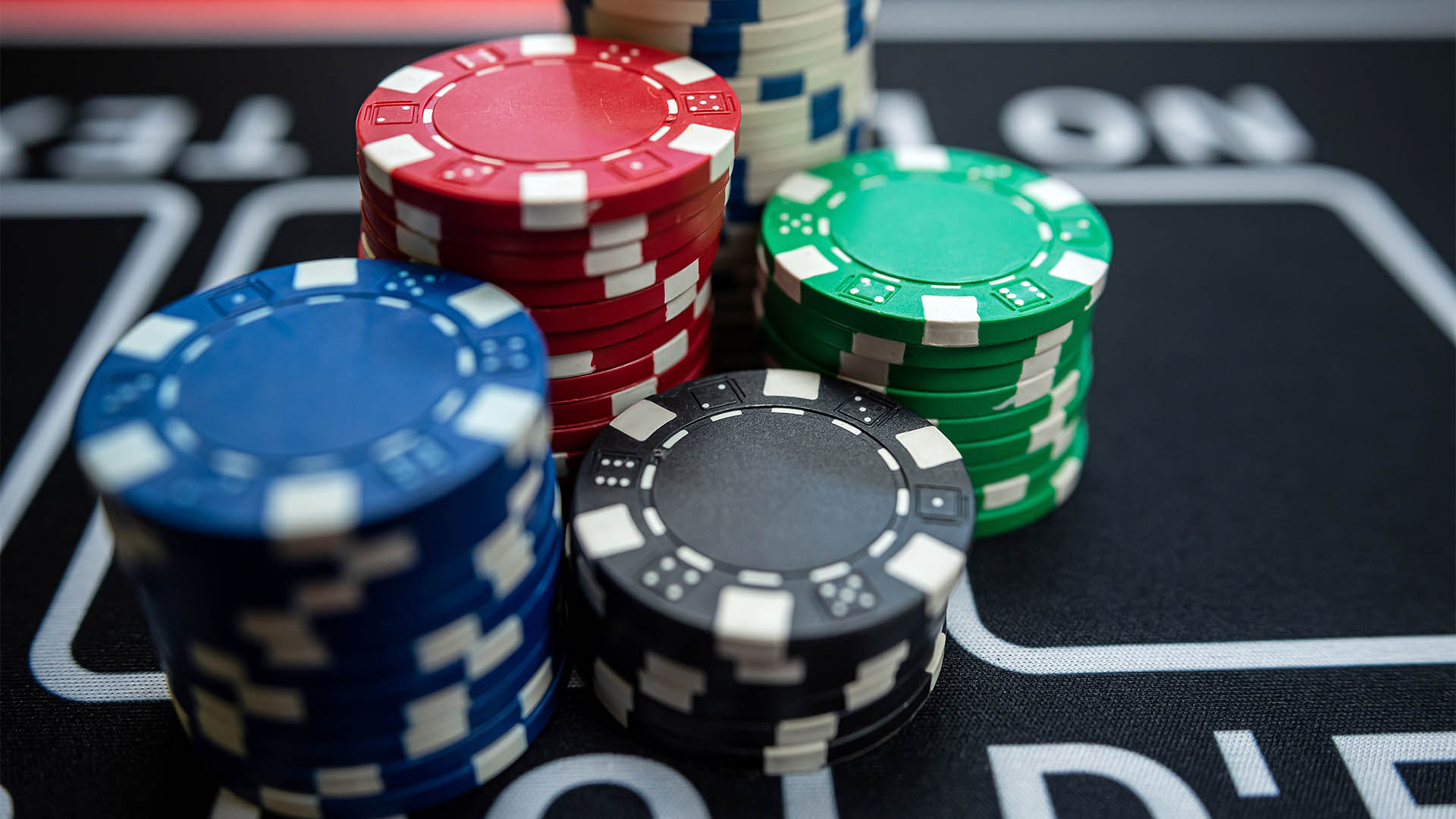 poker chips stack  on a black casino table. Poker game theme, gambling concept. Win and luck