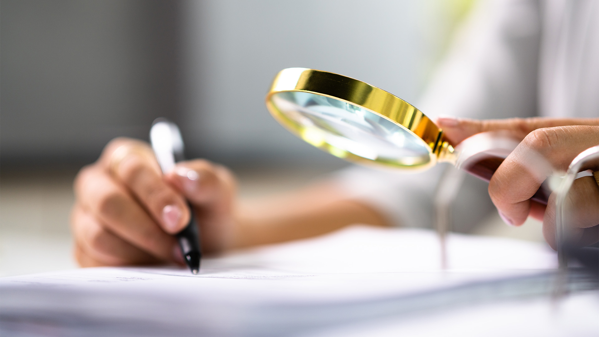 Auditor Doing Financial Audit And Tax Fraud Inspection Using Magnifying Glass