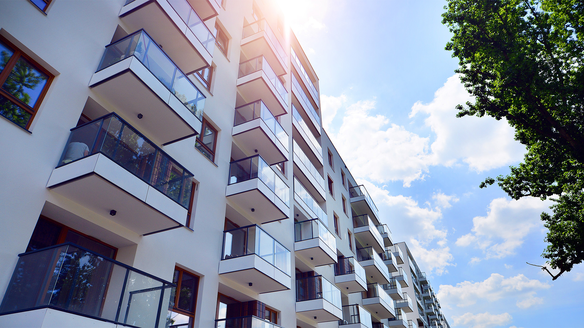 European residential architecture harmonizing with nature. Eco-friendly living in city with greens. Eco apartment building saving energy and fresh air concept.