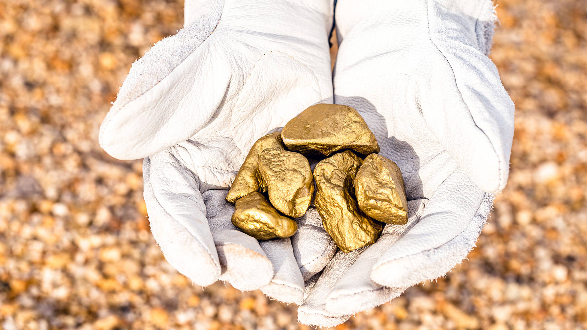 miner hand holding stones from another, gold mineral extraction, precious stone exploration concept.