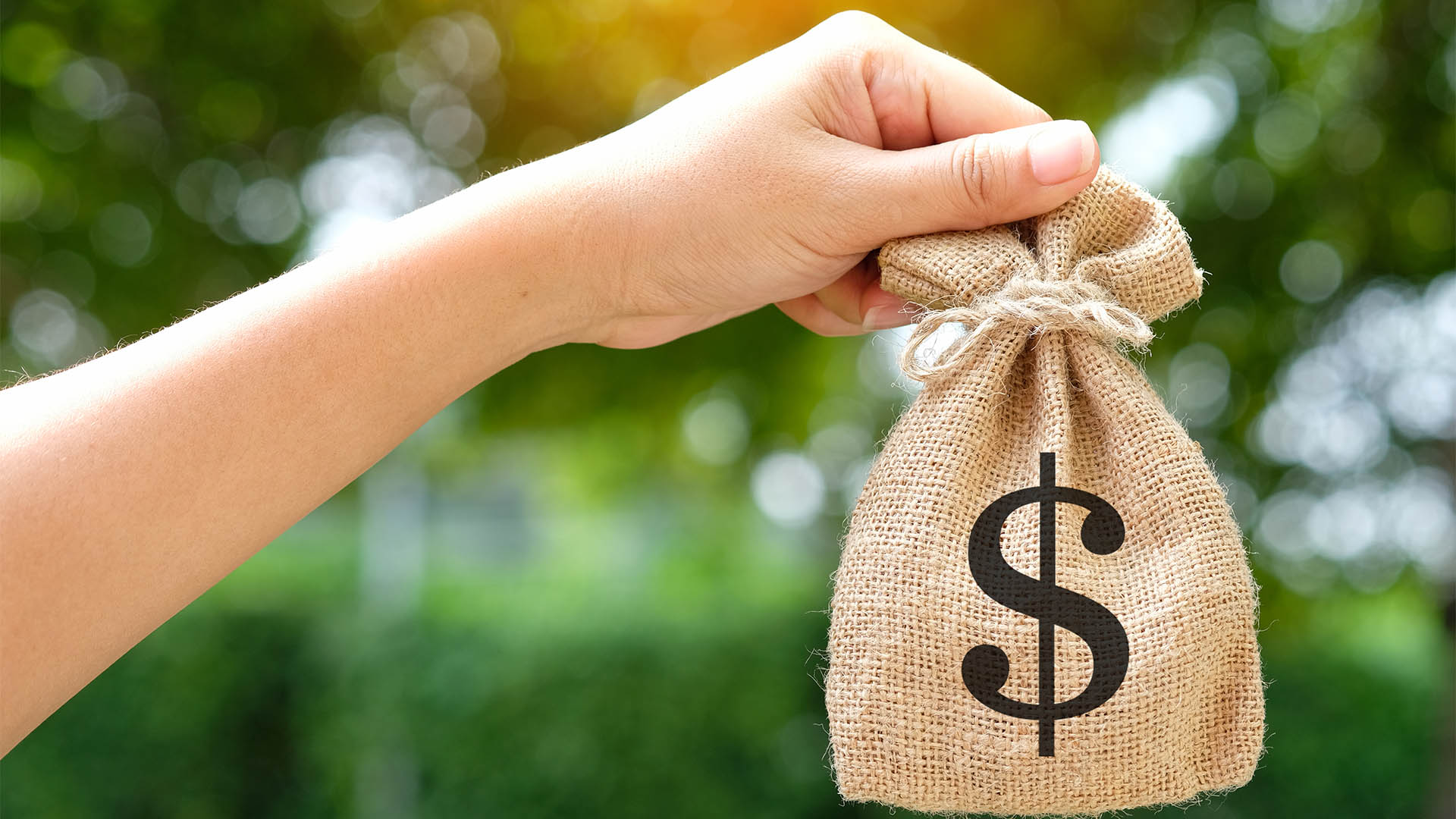 Hand of a woman carrying a purse money .concept saving money and investment concept