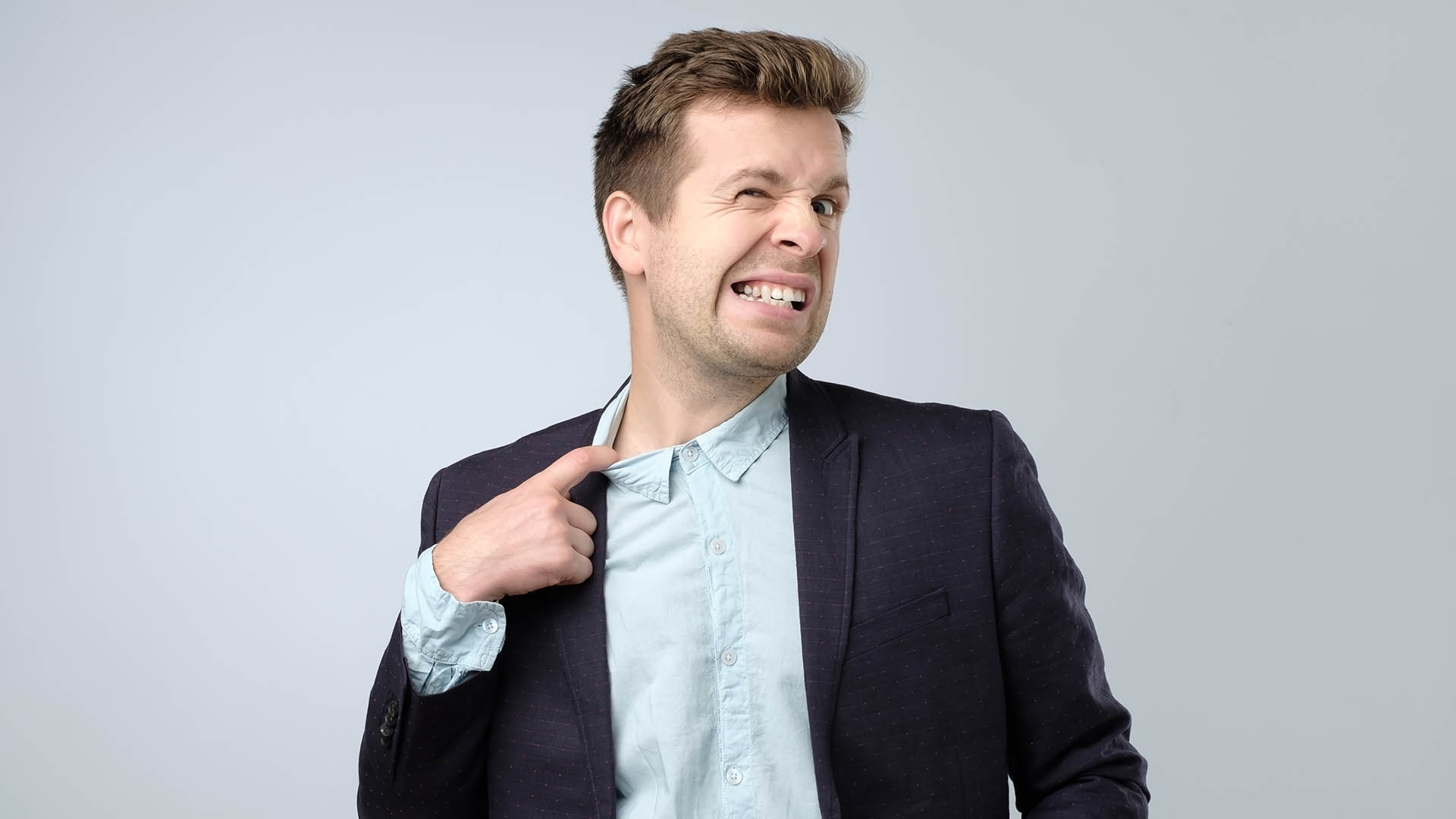 Sweating manager pulling his shirt with his finger feeling nervous and stressed. Narrow collar and uncomfortable clothes concept.