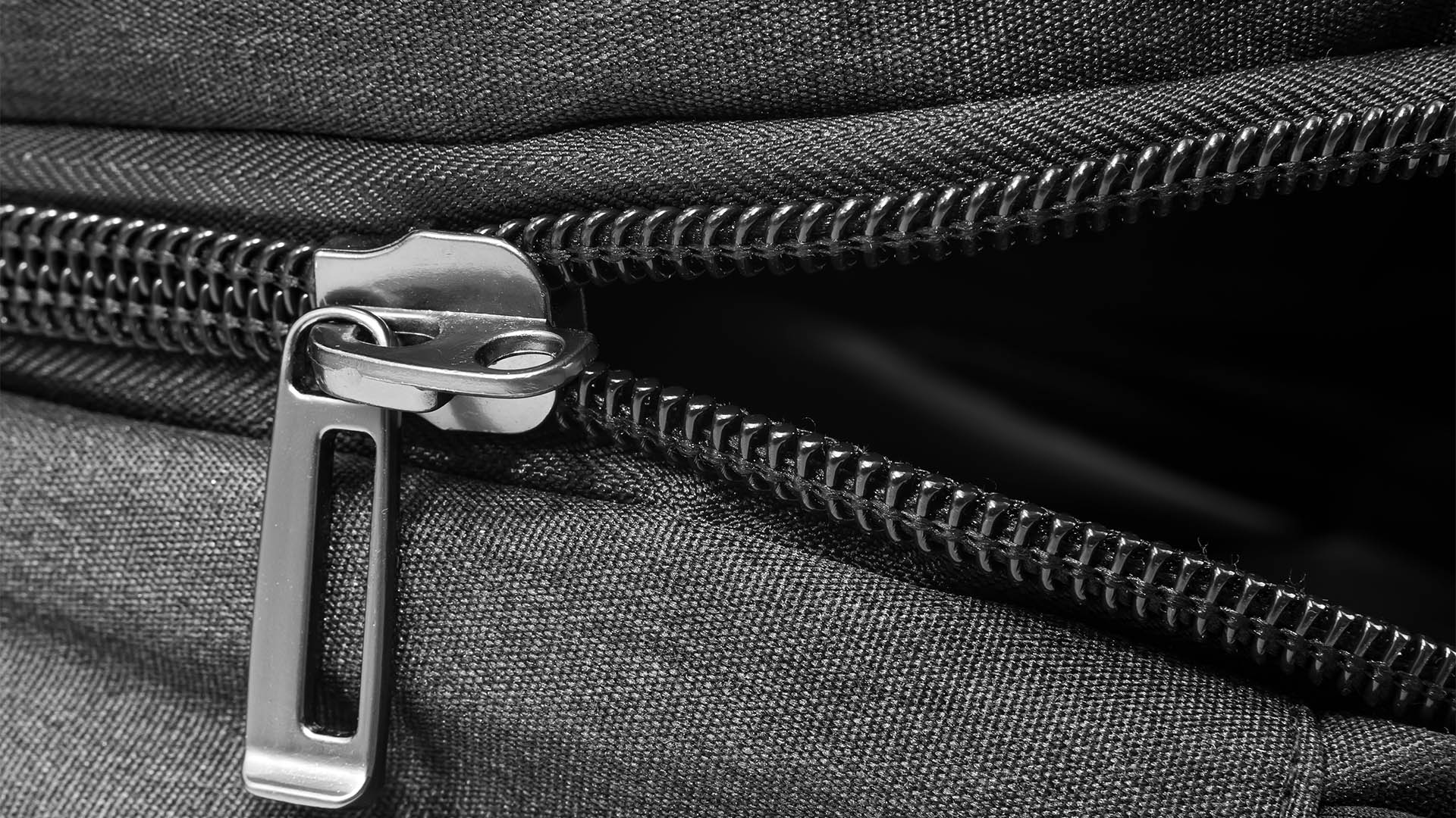 Silver lock with black zipper on clothes close-up. Zipper
