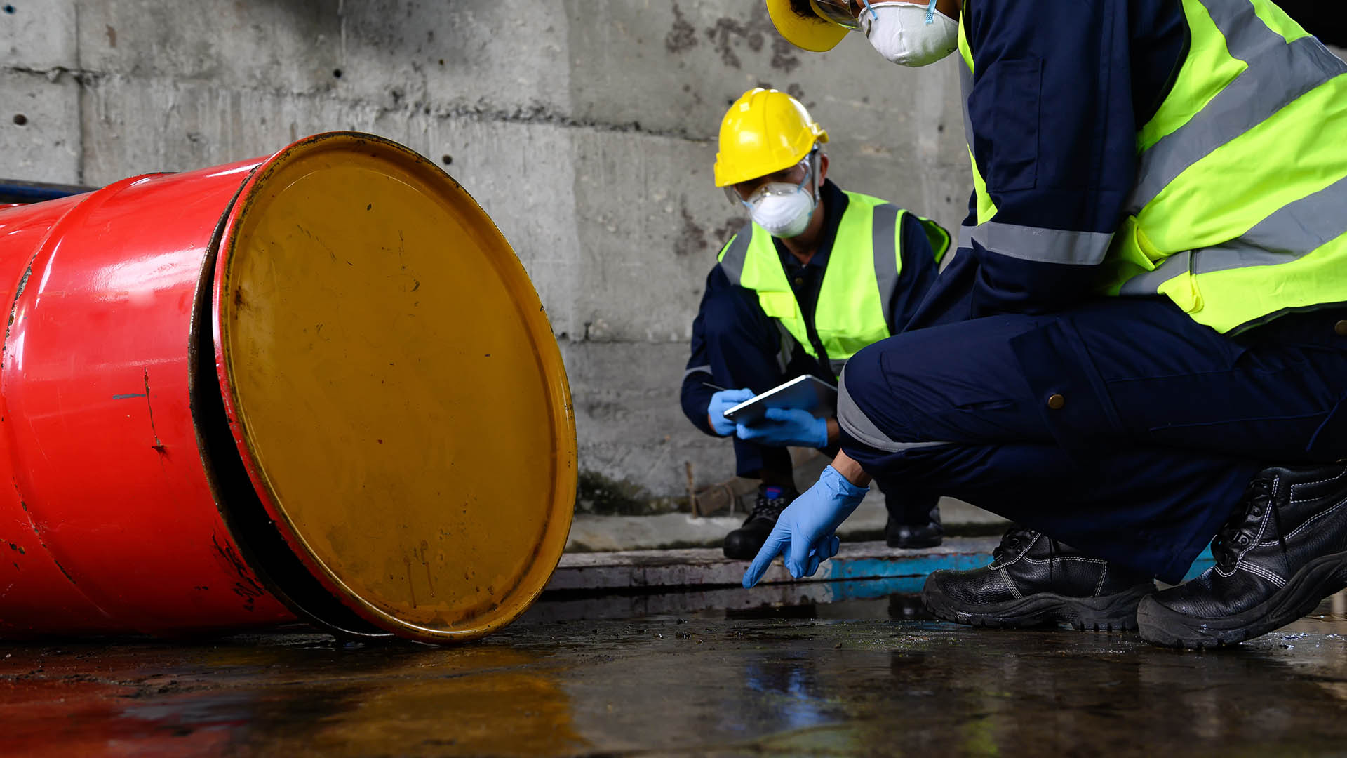Two Officers of Environmental Engineering Wearing Protective Equipment with Masks Inspected Oil Spill Contamination in Warehouse Old, Hazardous Fuel Leakage and Environmental Concept.