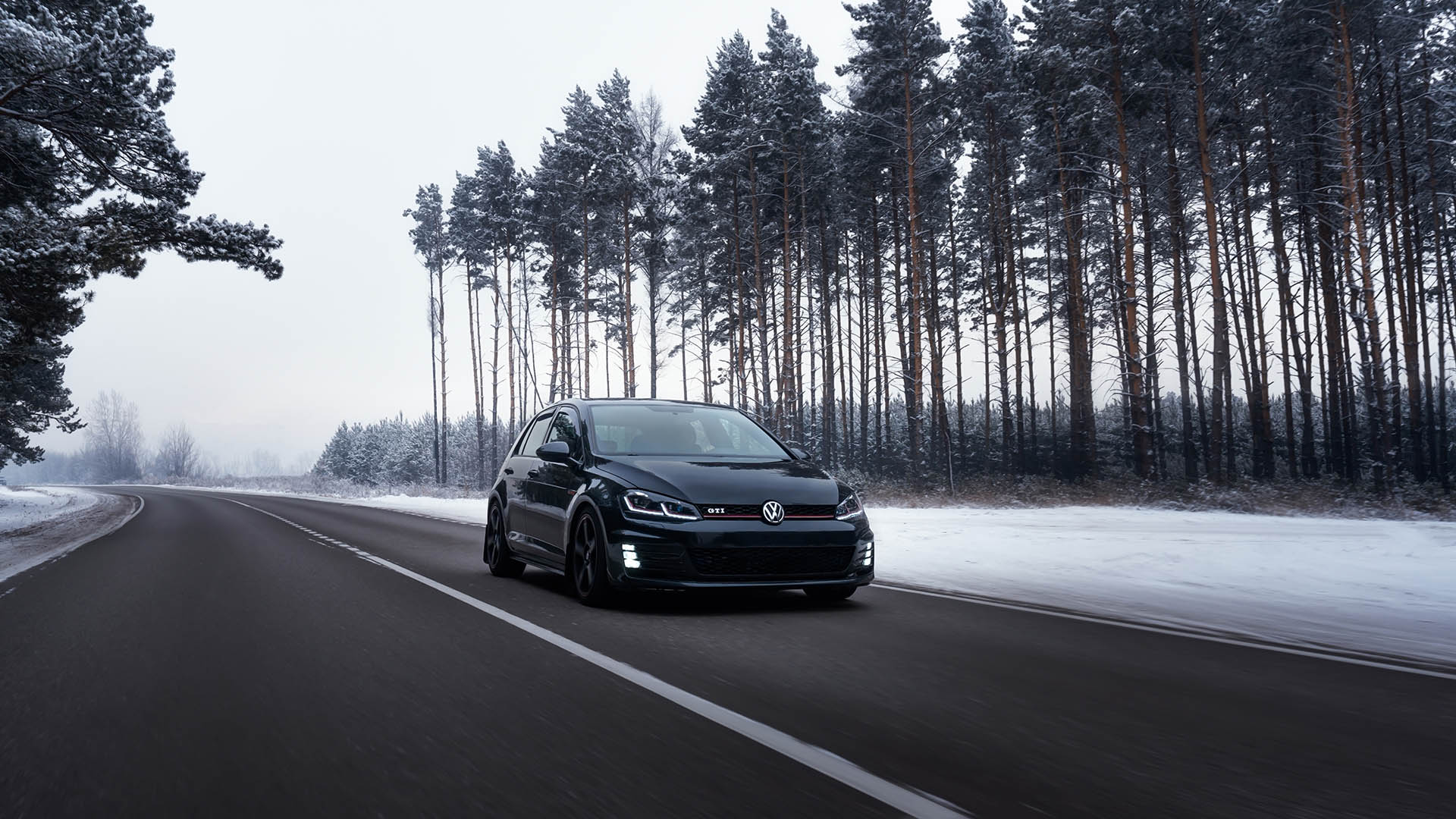 Helsinki, Finland - December 15, 2022 Volkswagen Golf Mk7 GTI on the road in the forest in snowy winter