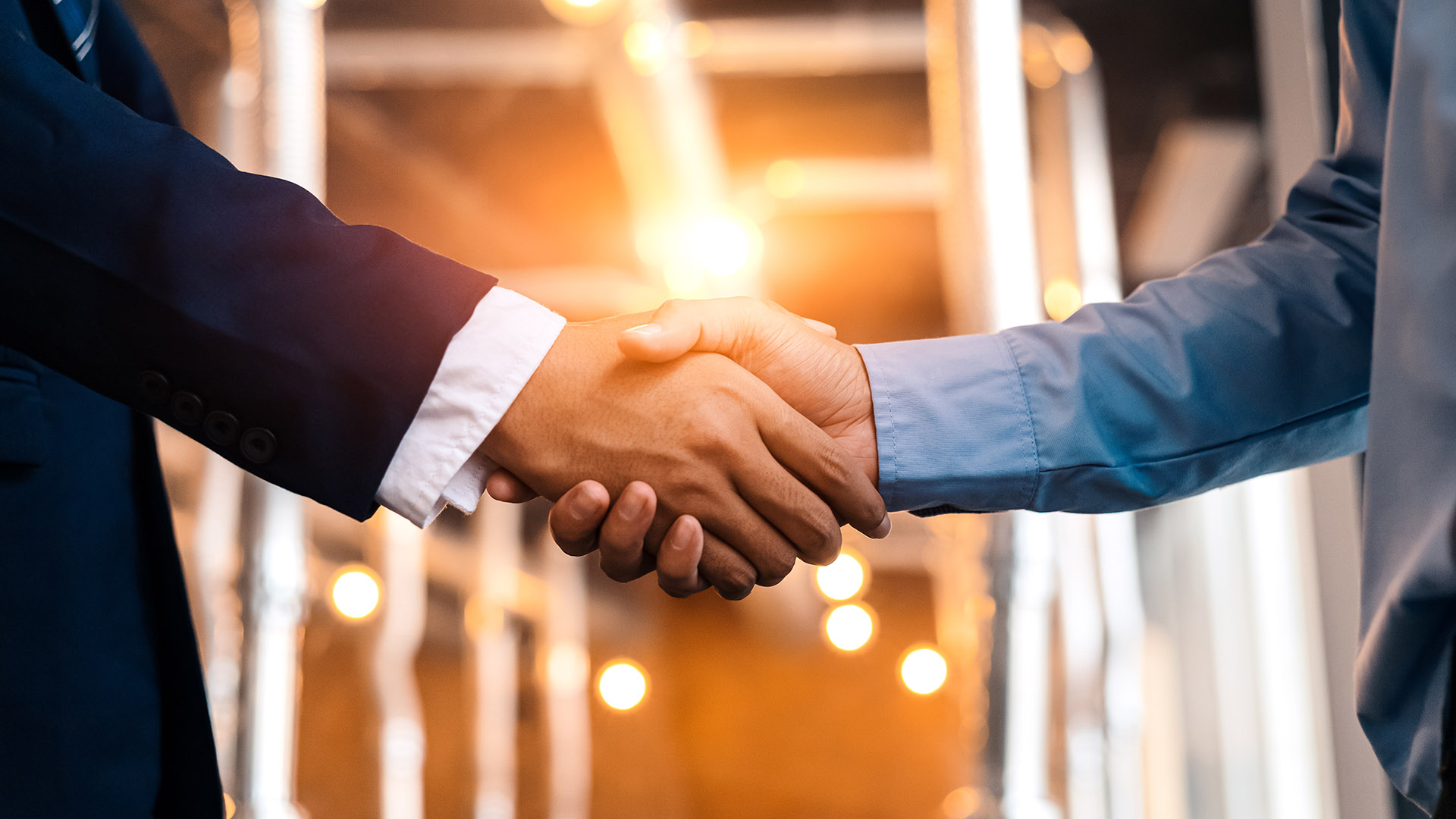 Business shaking hands, finishing up meeting. Successful businessmen handshaking after good deal.