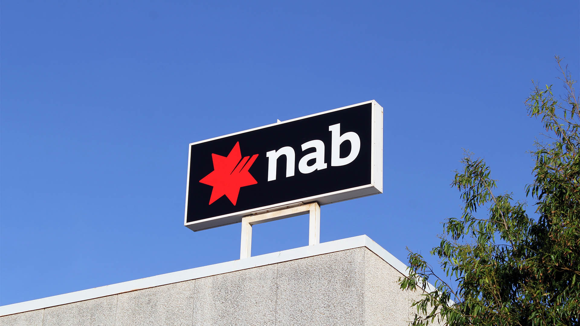 Gladstone, Queensland, Australia - January 4, 2024: NAB (National Australia Bank) logo signage against a blue sky