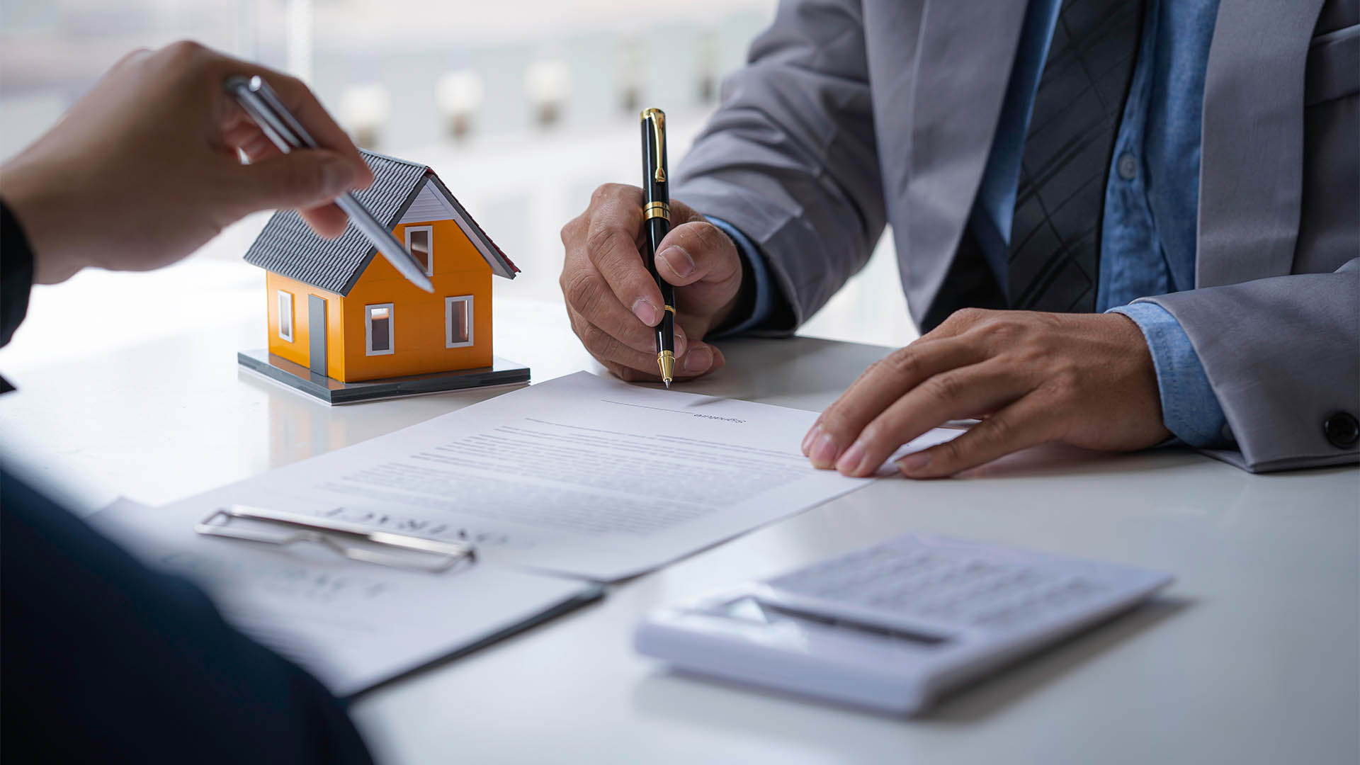 Discussion with a real estate agent, House model with agent and customer discussing for the contract to buy, get insurance or loan real estate or property.