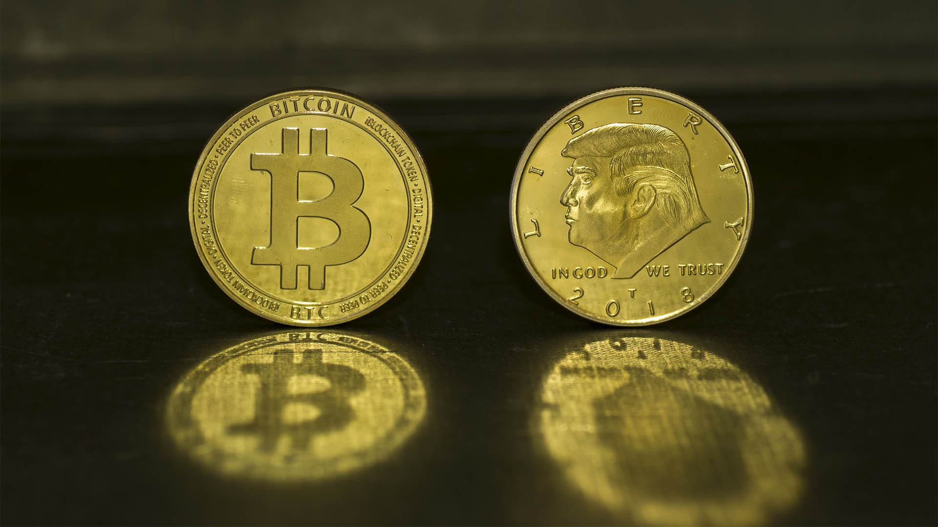 Barcelona, Spain - July 29 2019:  Bitcoin golden coin vs Donald Trump Coin