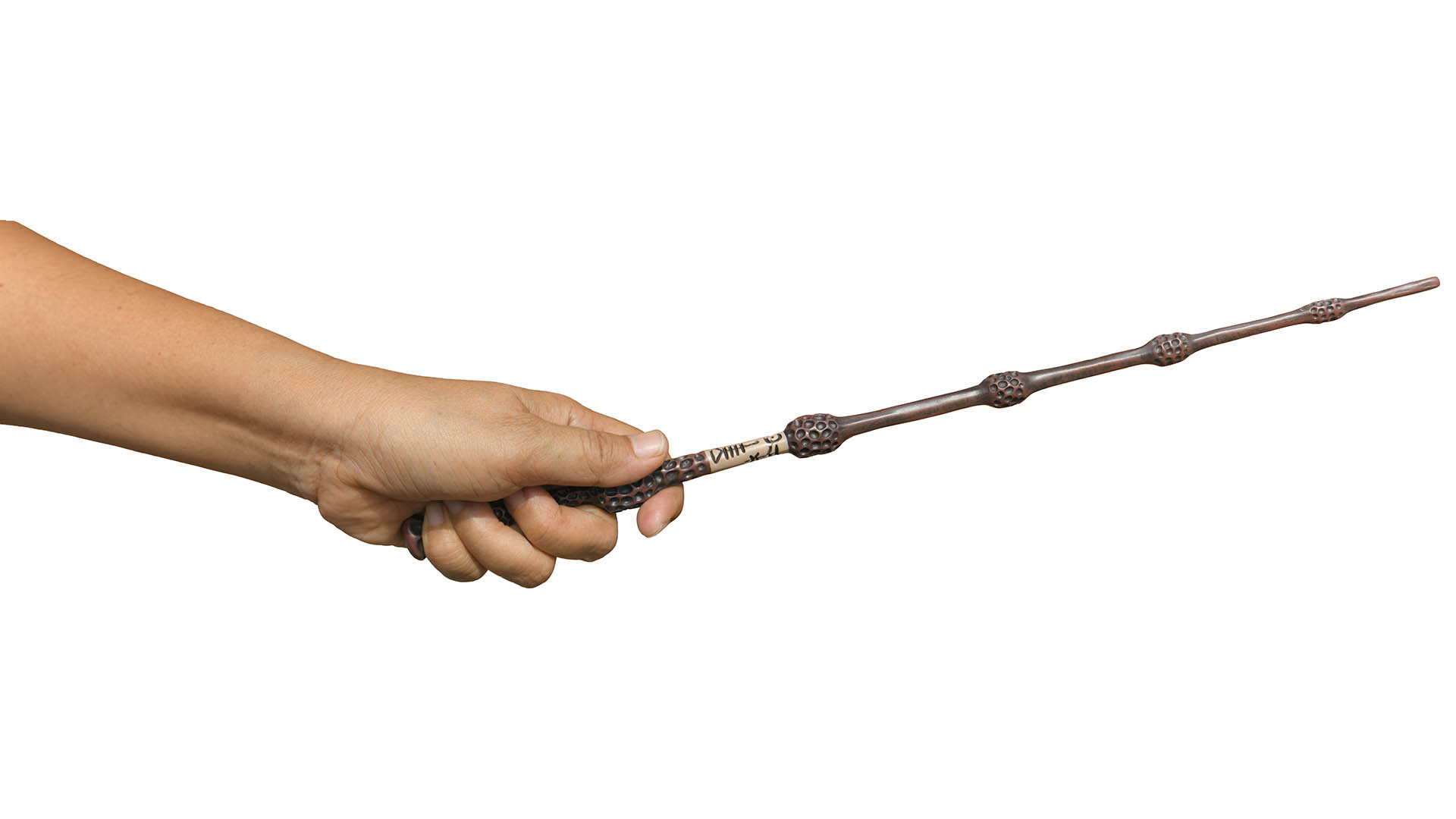 Hand holding Magic wand The wand was pointed up by the little wizards hand isolated on white background. This has clipping path.