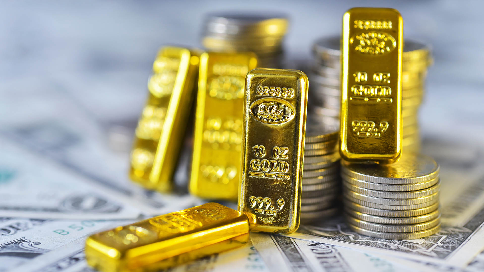 Gold bar lean against the stacking coins on  USD bills . Gold is hard commodity goods, risk asset, tangible value that used to be gold reserve, save assets during war and economic crisis